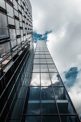 low angle photography of high rise building under cloudy sky